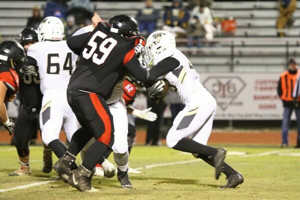 Photo courtesy of Terry Redman
No. 59, junior lineman Carlos Paiz, tries to fight off a block to get to this Versailles running back. The Tigers defeated Versailles to advance to the quarterfinal game, where they hosted Ava on Saturday afternoon.