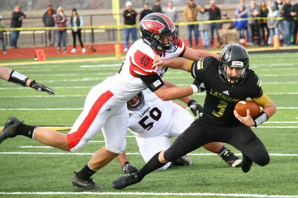 No. 40 senior linebacker Travis Bailey makes the tackle on this Mule running back. Also shown is No. 59 Juan Juarez.