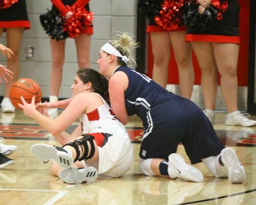 Lamar junior No. 32 Halle Miller gets down on the floor to retrieve a loose ball in girls action at Lamar High School. The Lady Tigers defeated Galena 50-32.