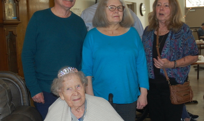 Lamar Democrat/Melody Metzger
The odds of being born a leap year baby are one in 1,461, so image what they are when a leap year baby turns 100! Margaret Wattenbarger celebrated her 25th (100th) birthday with a gathering at Truman Healthcare from 2 p.m. to 3:30 p.m. on Thursday, Feb. 29. Several family and friends, along with residents, joined in the celebration for Margaret. Tables were laden with goodies, cupcakes and punch and not only was there a cake wishing her a 100th birthday, but also a smaller one off to the side that was adorned with a 25 candle. A 100th birthday banner was also hanging behind the table that held the cakes. Margaret donned her birthday finery, complete with a tiara and her “fabulous” sash as she had her picture taken with her children, Jan, Jamie, Gary and Carol. Also pictured is Margaret visiting with her nephew, Kent Harris. Cards can still be sent to her at 206 W. 1st St., Lamar, MO 64759.