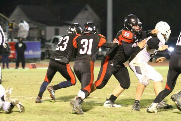 Photo courtesy of Terry Redman
No. 31 sophomore quarterback Noah Osborne follows the blocking of junior lineman George Weber and sophomore running back, No. 23 Johnathan Contrares, gain good yardage for the JV offense. The Tigers hosted the Ava Bears in action on Saturday.