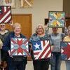 A barn quilt class, taught by Angie Lathrop of Vintage Chaos, was held at the University Extension Center in Lamar on Tuesday, Oct. 20. Pictured are a few of the colorful barn quilts that participants made during the evening.